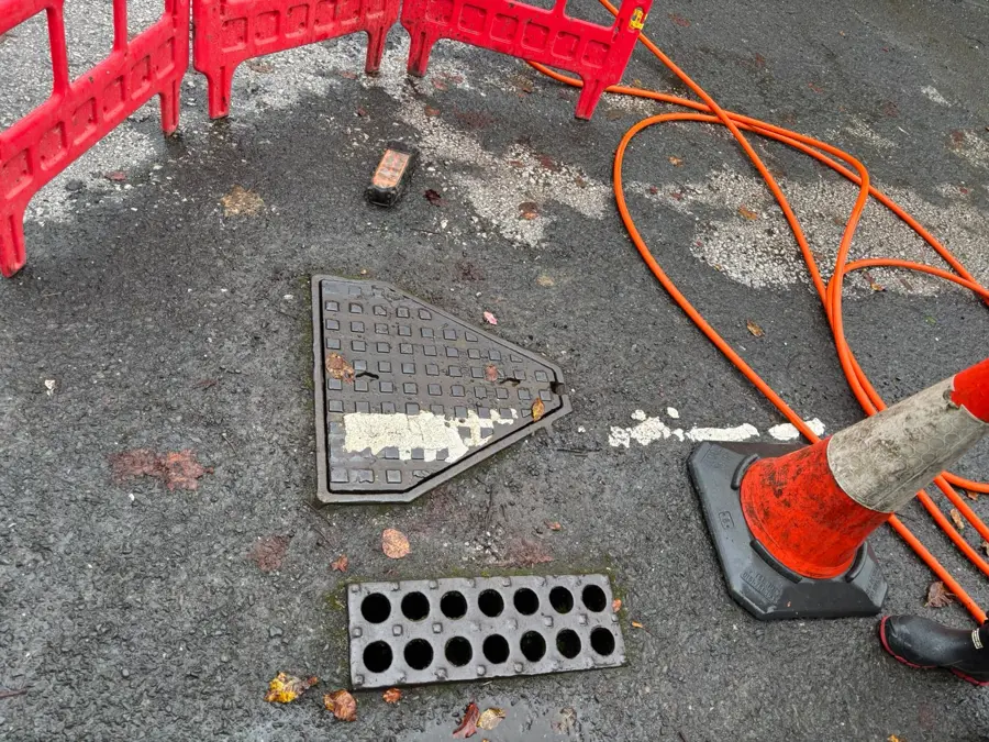 The access cover lifted and barriers set out on Carr Road, Burnley