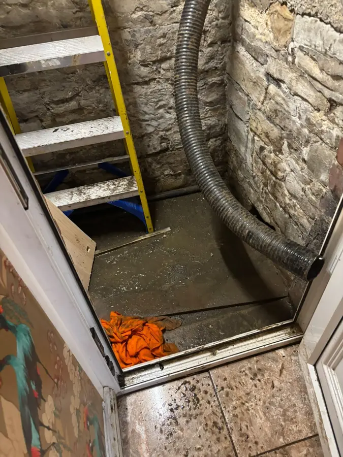 Suction hose running into the cellar on Carr Road, Burnley