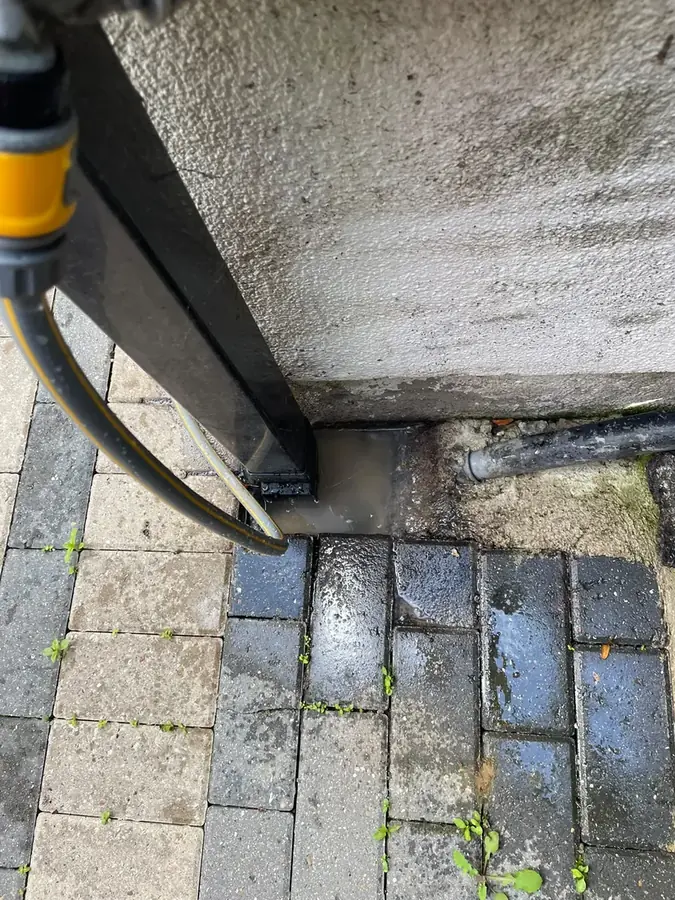 Jetting hose clearing and flushing the gully line on Casterton Avenue, Burnley
