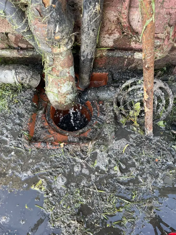 The cleared gully being flushed through on Leamington Avenue, Burnley