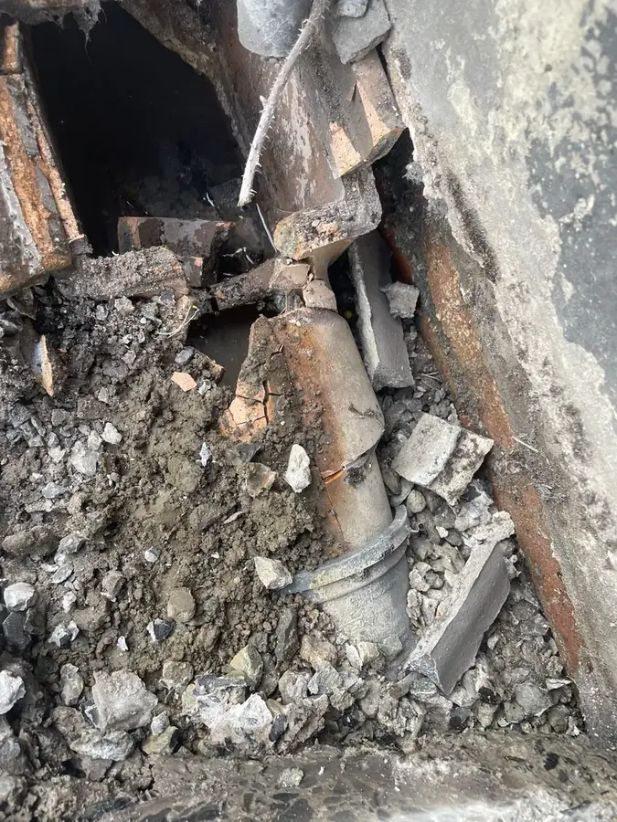 Excavation exposing the cracked gully and defective pipework on Marine Avenue, Burnley