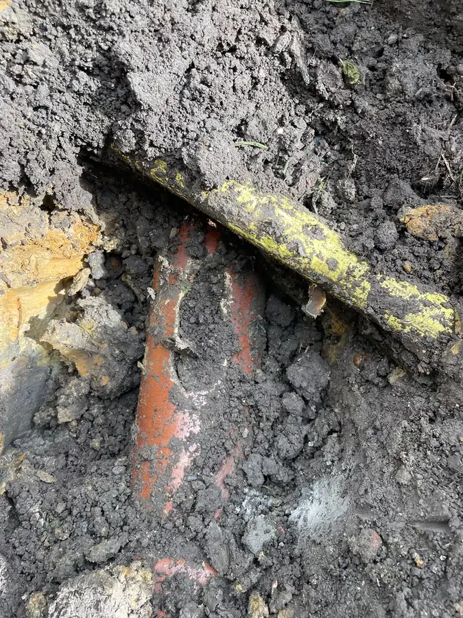 Excavation exposing the defective pipe with concrete inside on Marine Avenue, Burnley