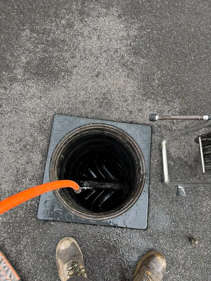 The manhole opened with the jetting hose in place on Royal Court, Burnley