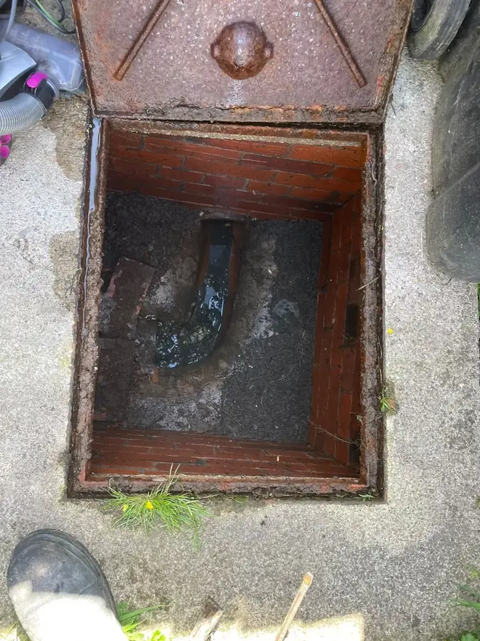 The surcharged chamber before clearing on Rydal Close, Padiham