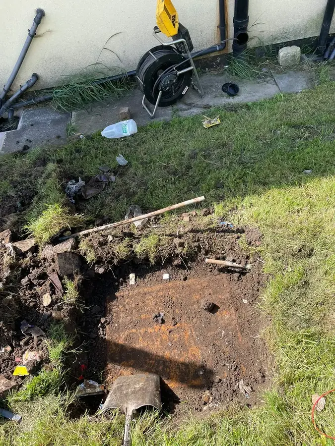 Excavating to uncover the buried manhole on Waddington Avenue, Burnley